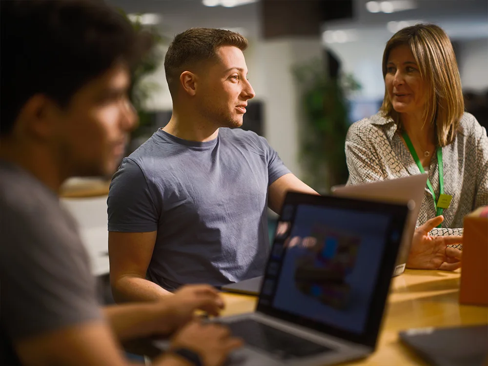 JLP partners on the IT team sat at laptops in meeting