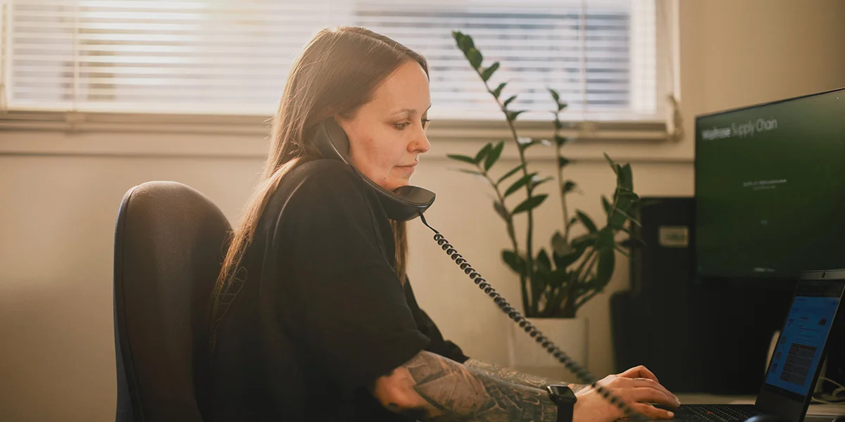 Administration employee making a call at the computer