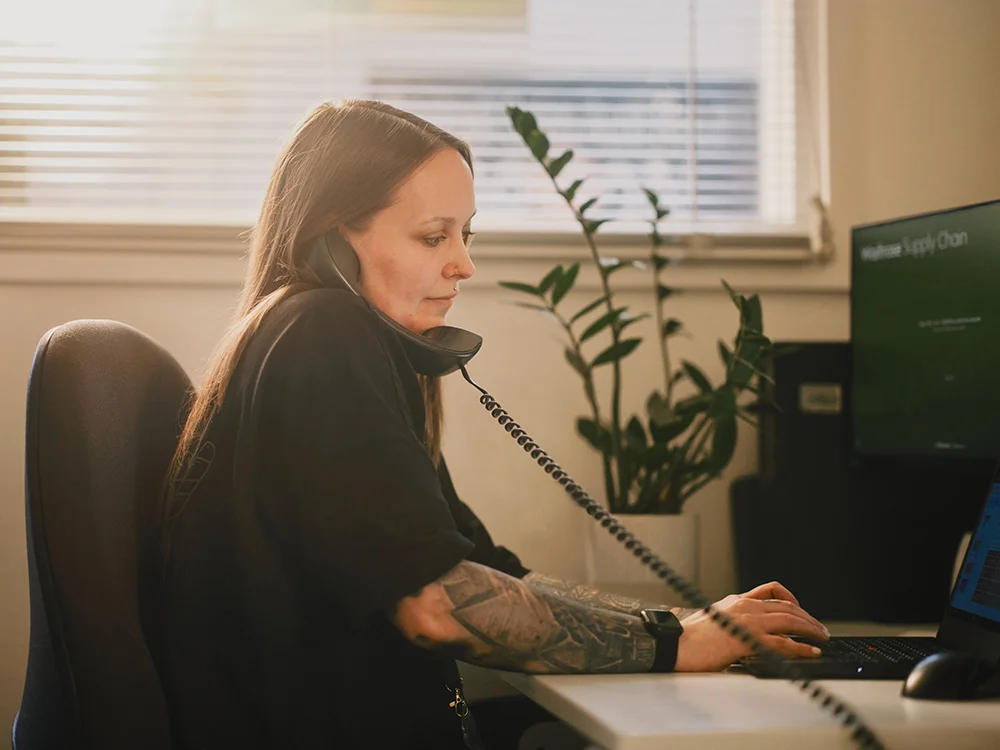Administration employee making a call at the computer