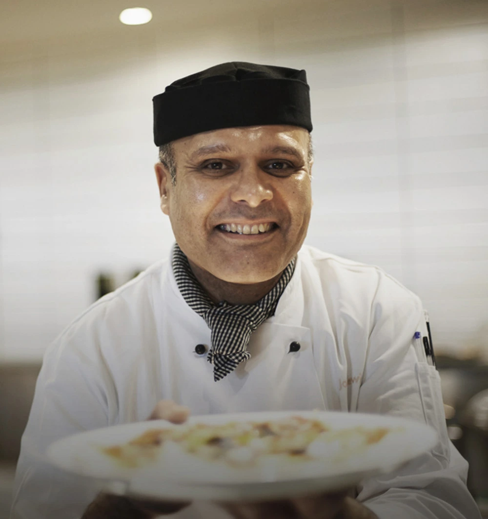 Chef offering a plate of food