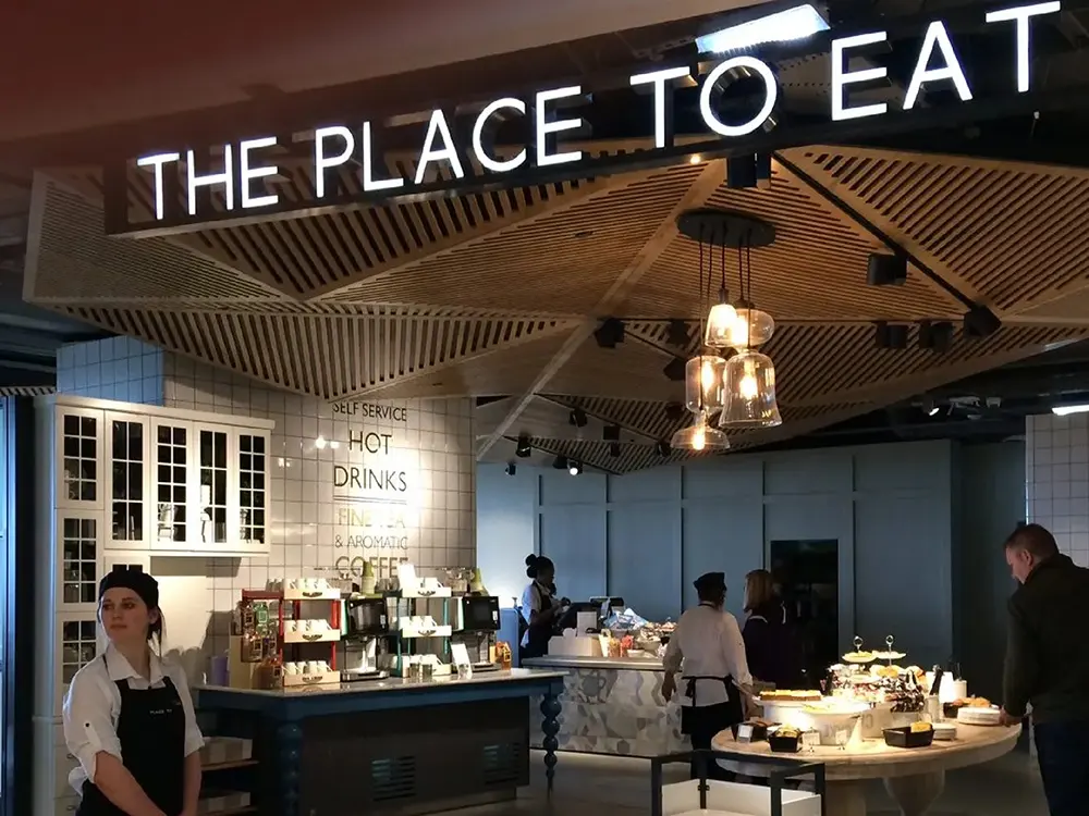 Well-lit cafe with a sign reading 'The Place to Eat