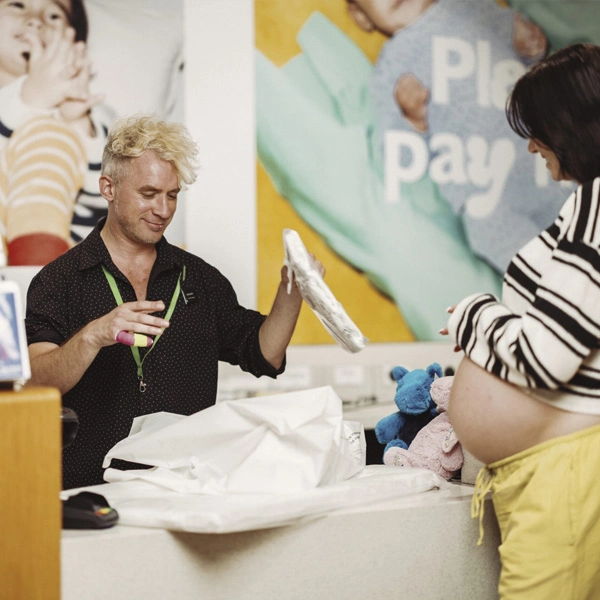 Young man serving pregnant woman