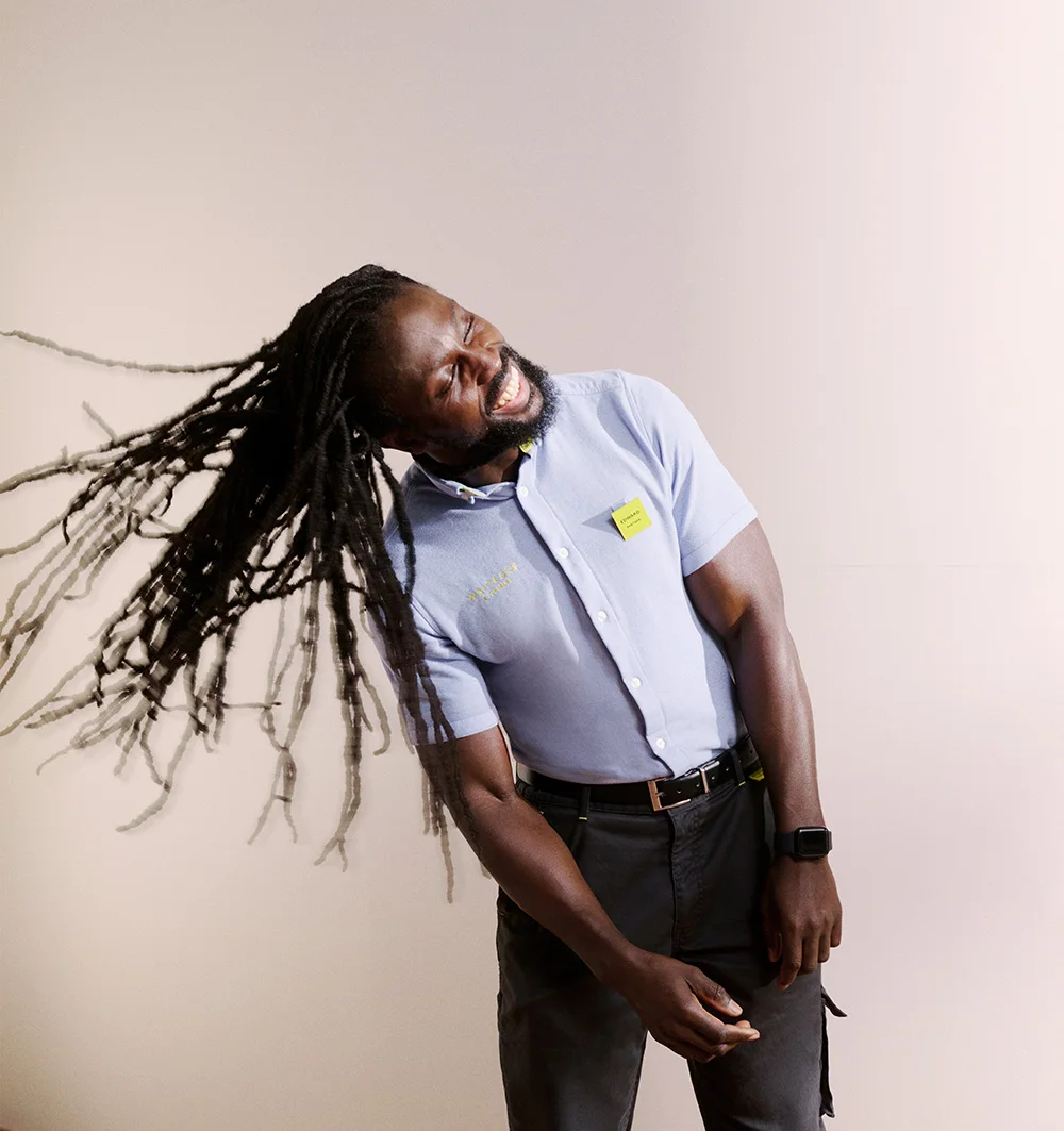 Person joyfully tossing his dreadlocks