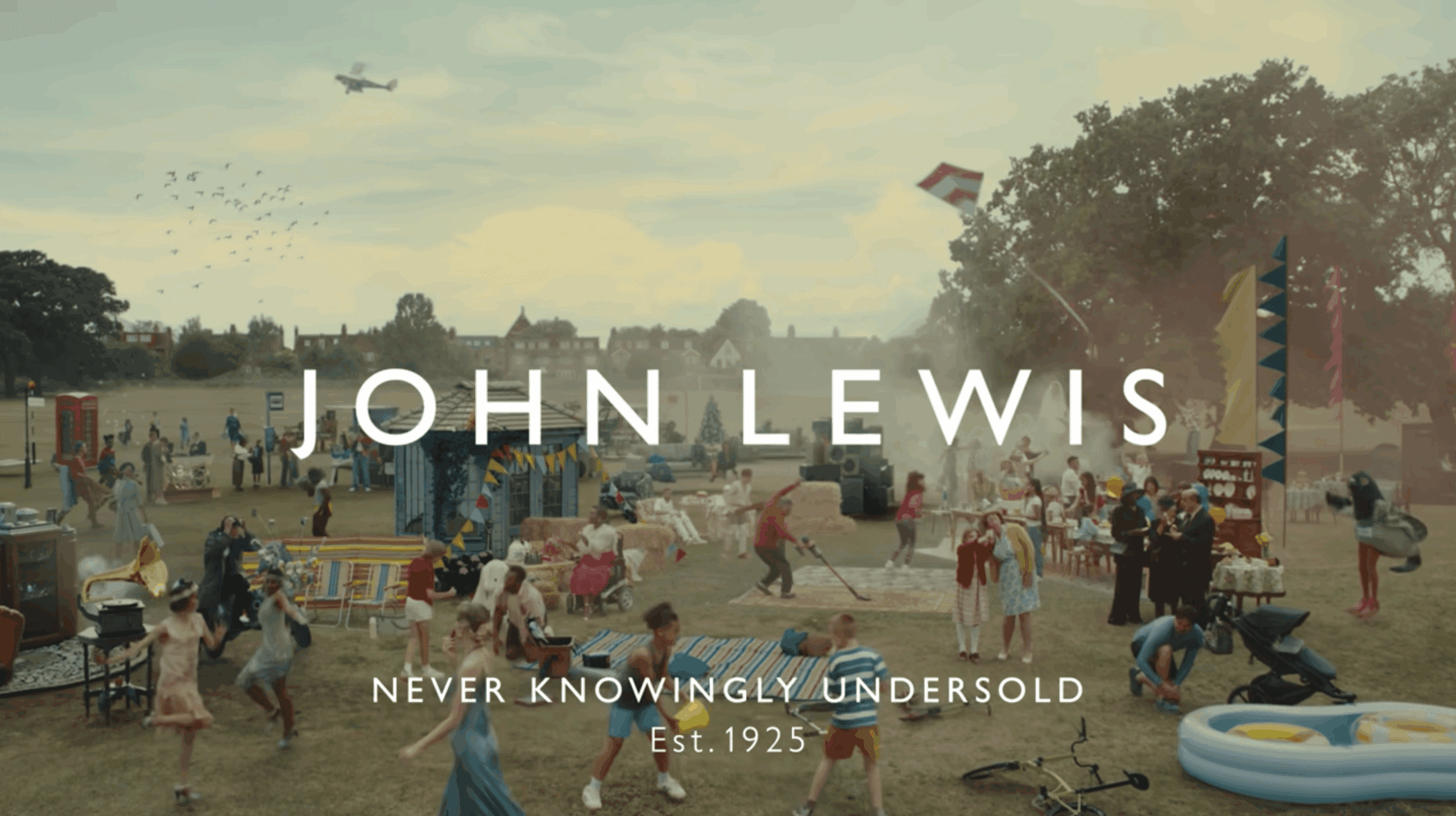 Screenshot from the advert with the 100 actors and the John Lewis Logo