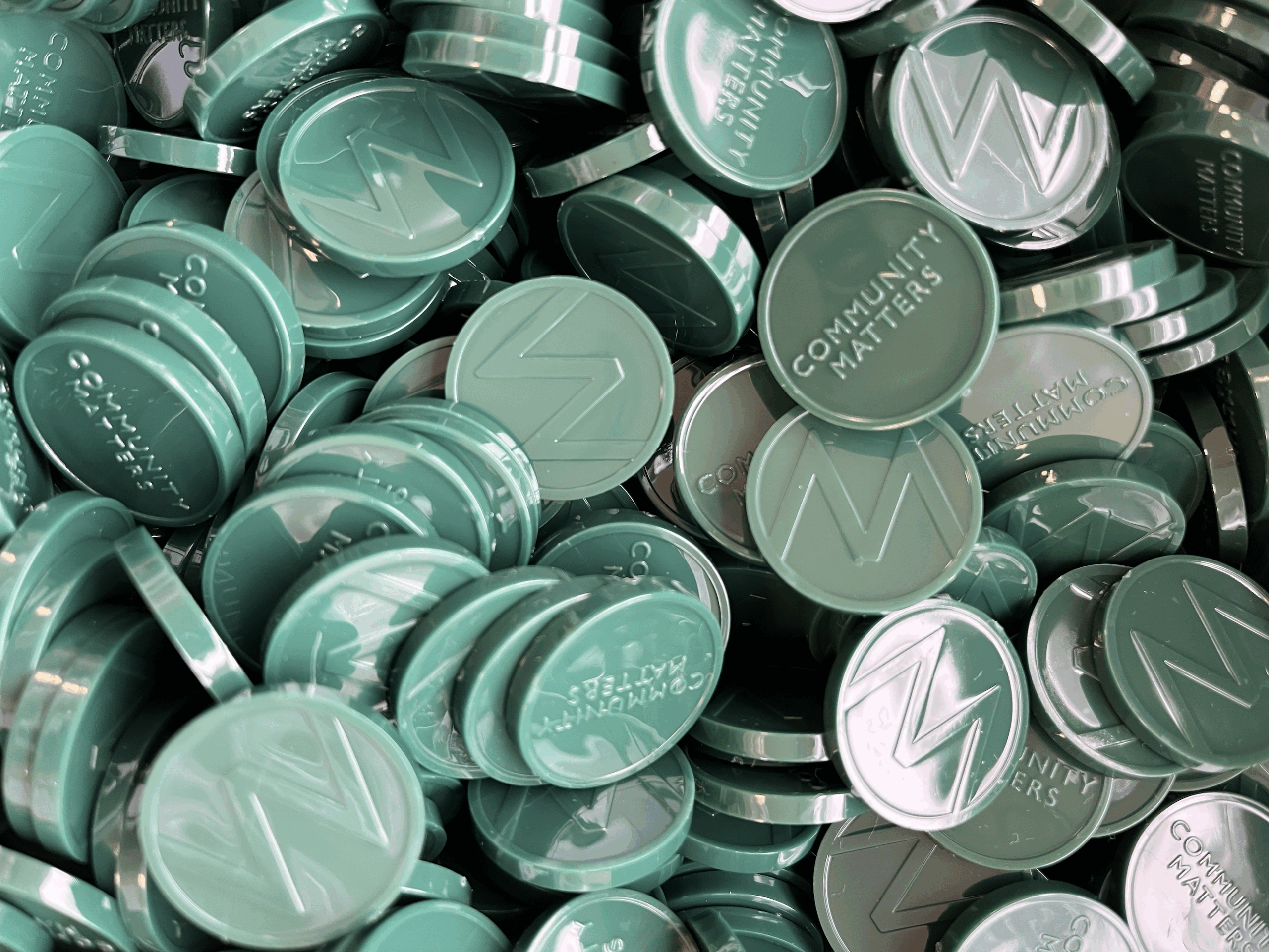 A pile of Waitrose Green Tokens